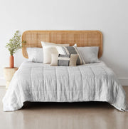 Styled bed with light cane headboard