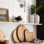 Neutral ceramic vases on open shelving in kitchen