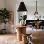 Neutral ceramic vases on round table in entryway