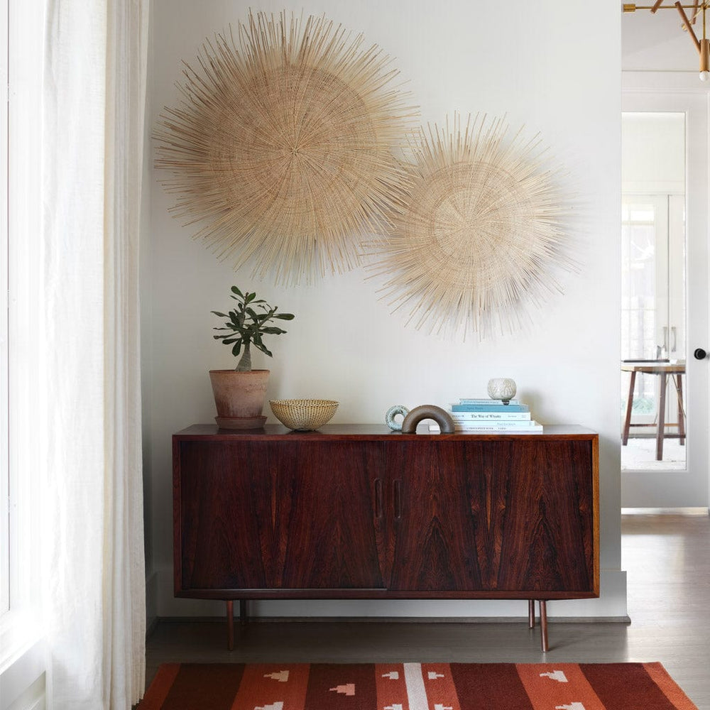 Set of Two Palm Wall Hangings above Modern Credenza