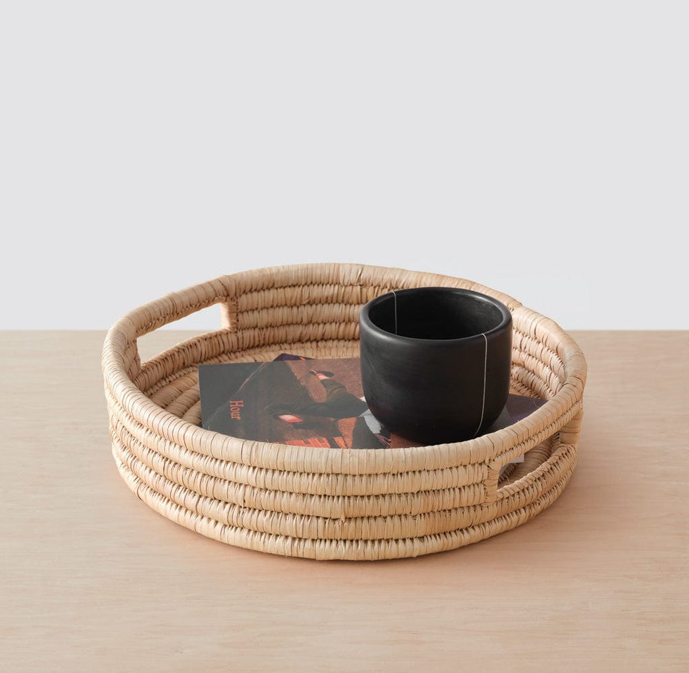 Ceramic mug in small woven palm tray