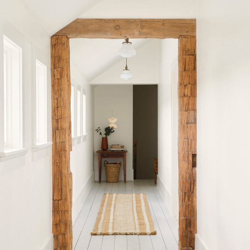 Chunky wool runner styled in hallway with beams, mustard