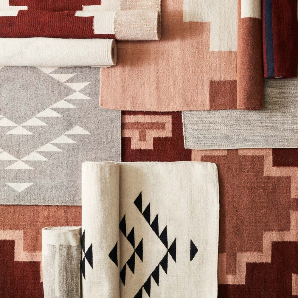 Handwoven Wool Accent Rugs in Rust and Neutral Tones Layered Overhead