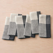 Six napkins folded, charcoal