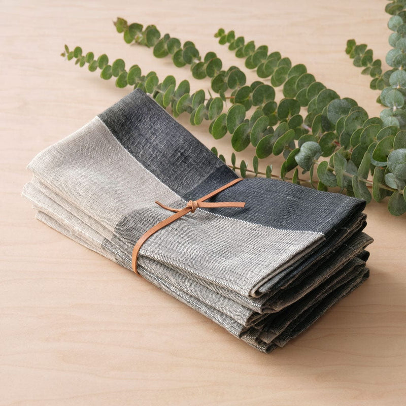 Napkins bundled in leather tie, charcoal