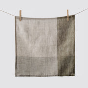 Napkin hanging from clothespins, olive