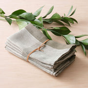 Napkins bundled in leather tie, olive