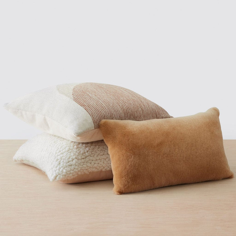 Sheepskin and alpaca pillow stacked