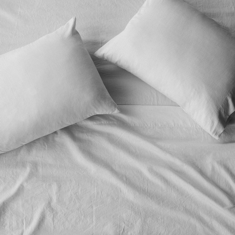 Overhead of pillows on duvet, light-grey-stripe