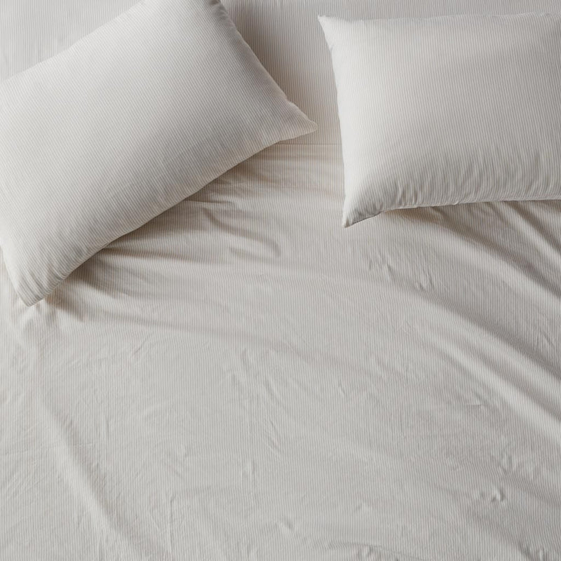 Overhead of pillows on duvet, sand-stripe