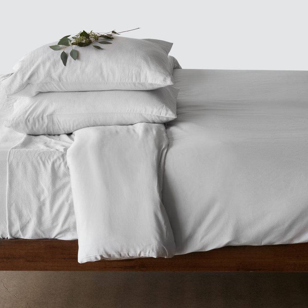 Side of bed with pillows stacked