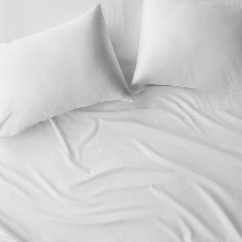 Overhead of turkish cotton pillowcases on duvet, white