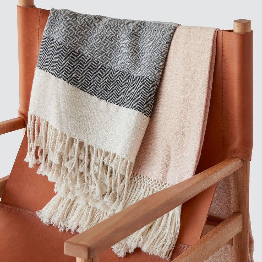 Grey and Blush Alpaca Blanket Draped Over Chair
