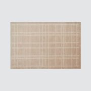 Overhead of striped area rug, sand