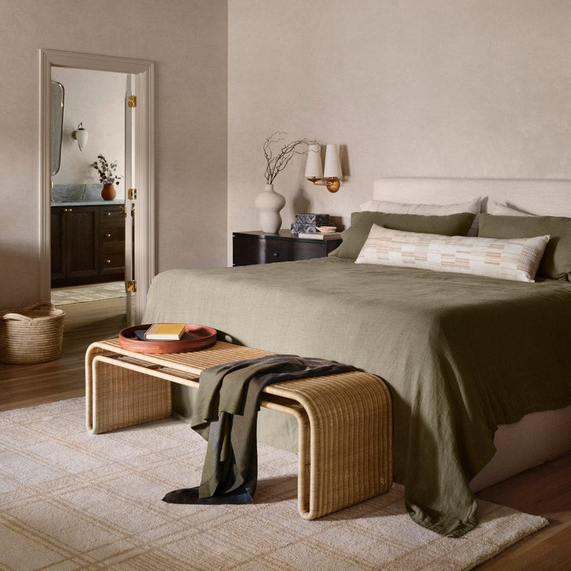 Penida wicker bench at the foot of an upholstered bed, natural