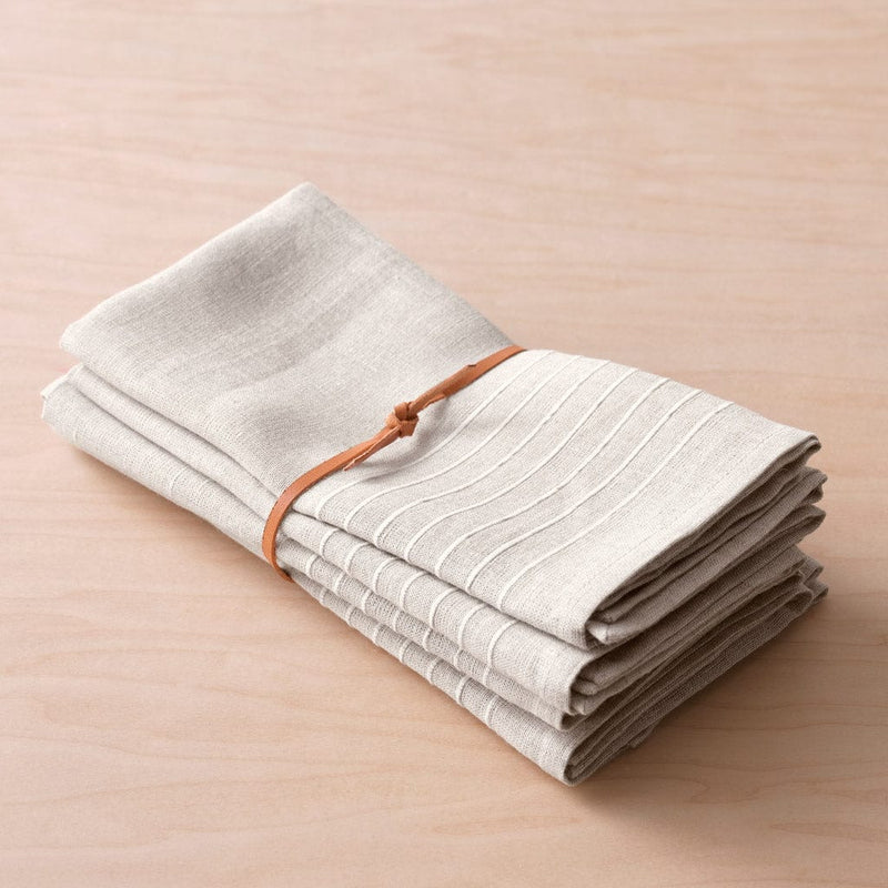 Folded napkins with leather tie, flax