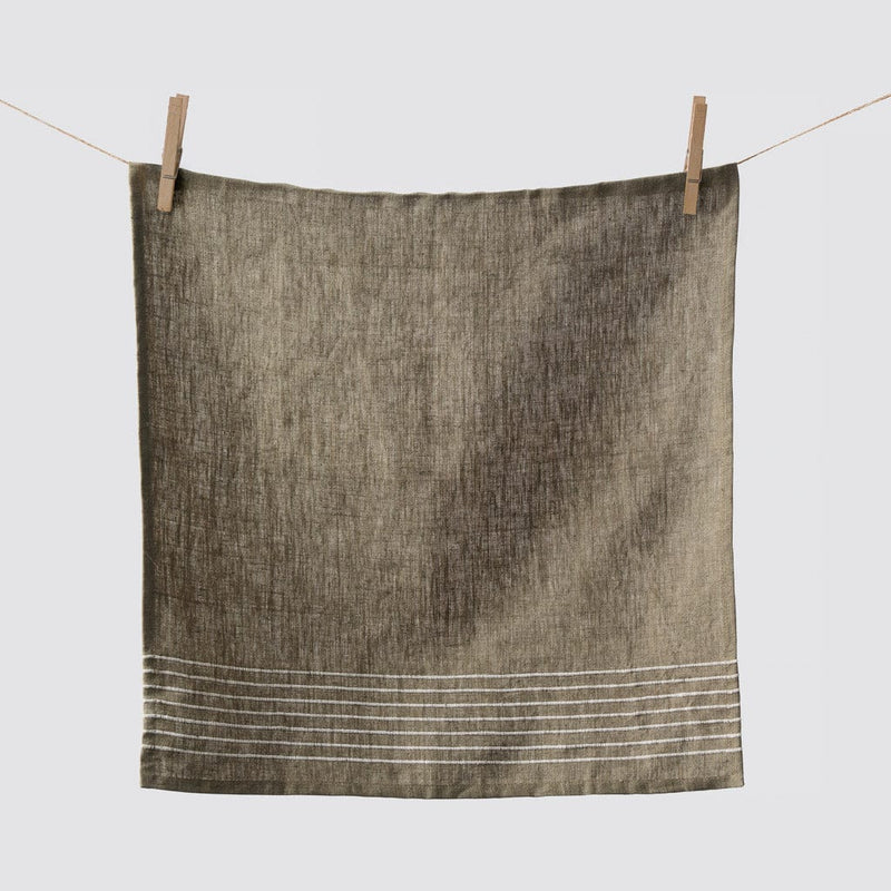 Napkin hanging from clothespins, olive