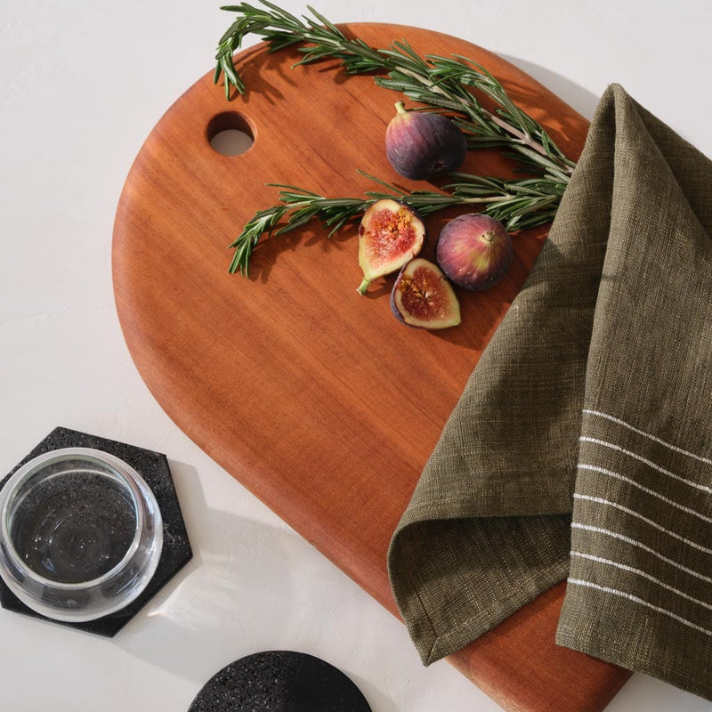 Linen napkins with wood serving board and black lava rock coasters, olive