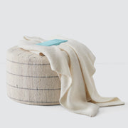 Cream throw on ottoman, stripe
