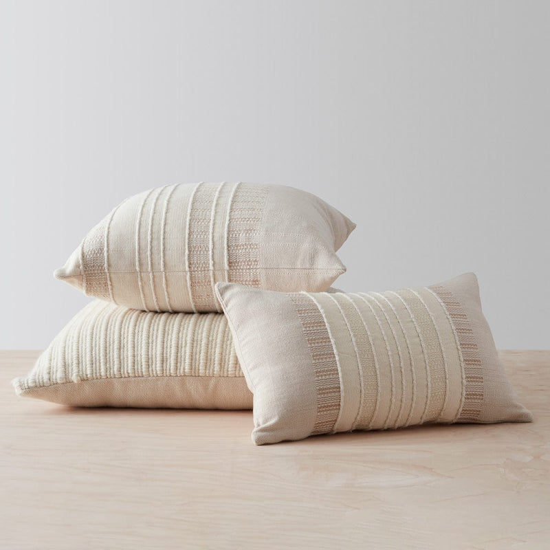 Stack of neutral textured pillows, tan