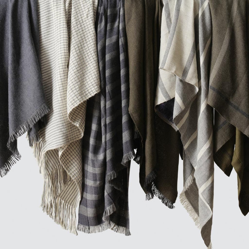 Blue, grey, and cream throws hanging, olive-grey