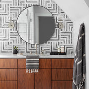 Modern bathroom with woven towel hanging on sink, black