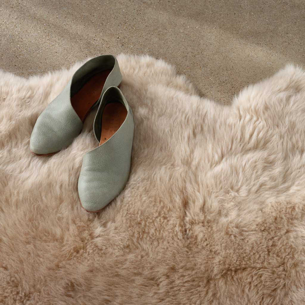 Tan sheepskin rug with robin's egg blue shoes