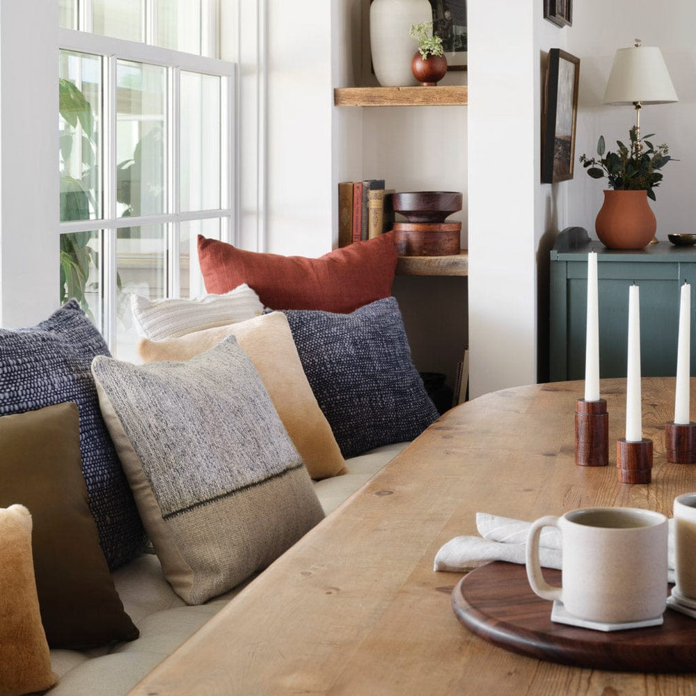 Dining banquette with moody blue and rust and tan throw pillows