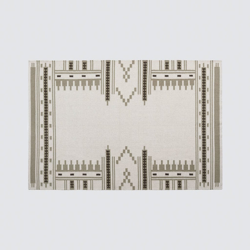 Overhead of sage and cream patterned area rug, sage