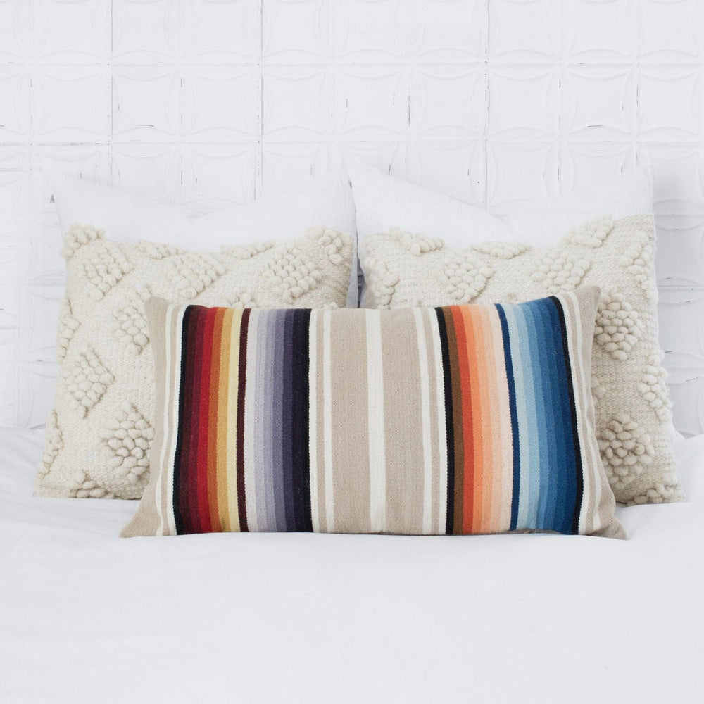 Colorful Accent Pillow and Cream Wool Pillows on bed