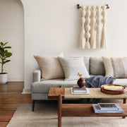 boucle pillow styled in living room, sand