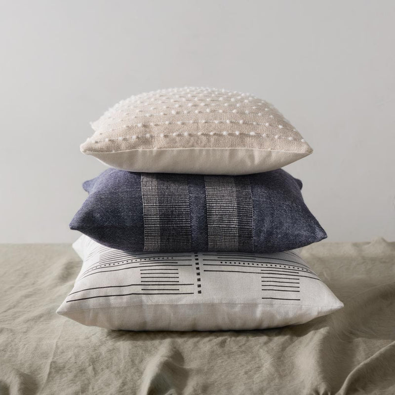 boucle pillow styled with throws, sand