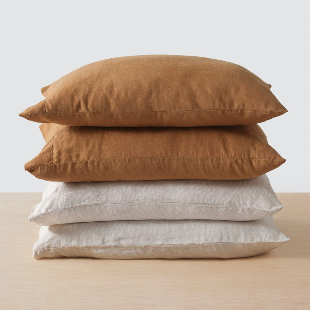 Stack of four pillows in camel and sand stripe