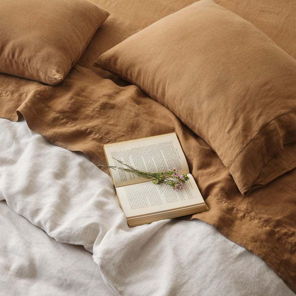 Styled bed with camel and sand stripe sheet set