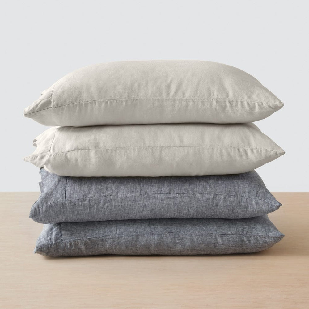 Stack of four pillows in indigo chambray and tan 