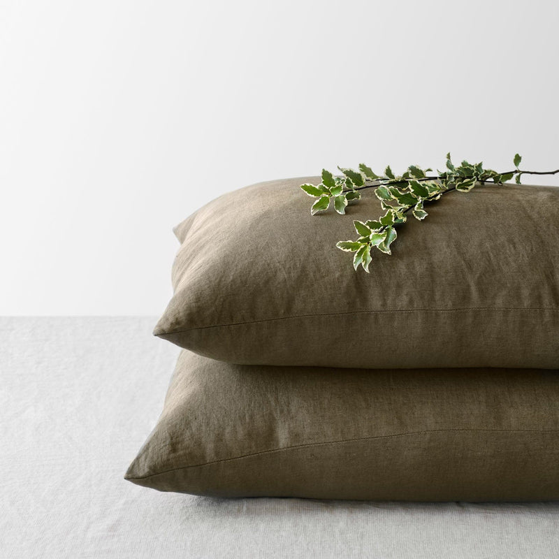 Corner of Olive Linen Pillowcases in a Stack, olive