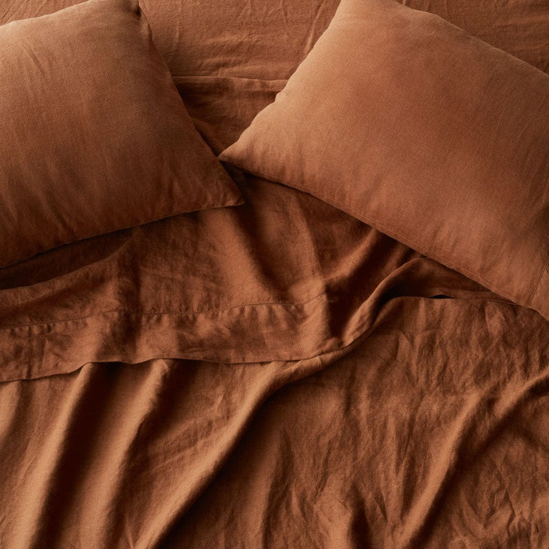 Overhead of sienna linen sheet set and pillows, sienna