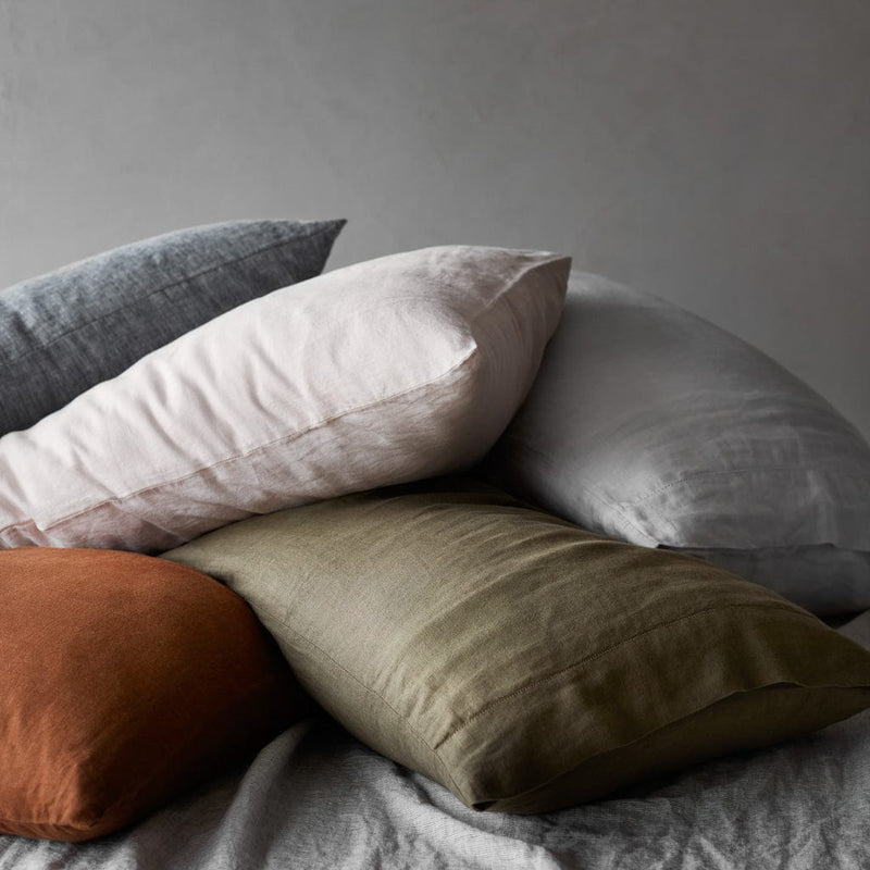 Pile of multicolored linen pillows, sienna