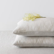 Corner of Beige Striped Linen Pillowcases in a Stack, sand-thin-stripe