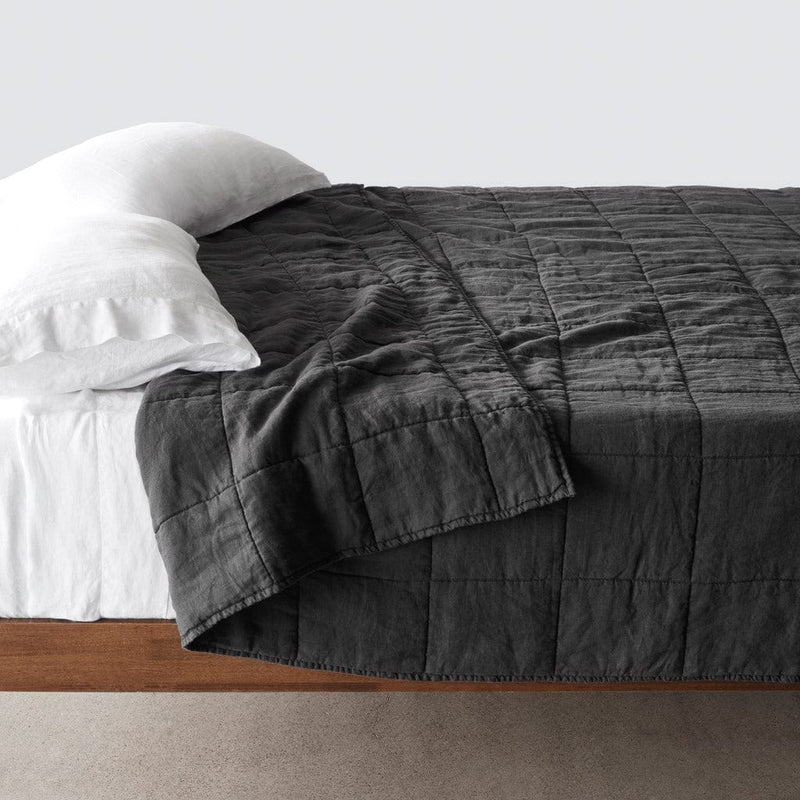 Side of bed with charcoal stonewashed linen quilt, charcoal