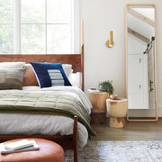 Olive green quilt folded at foot of bed, olive