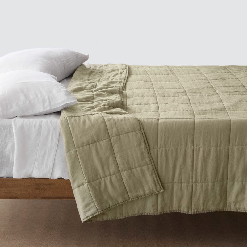Side of bed with sage green stonewashed linen quilt, sage