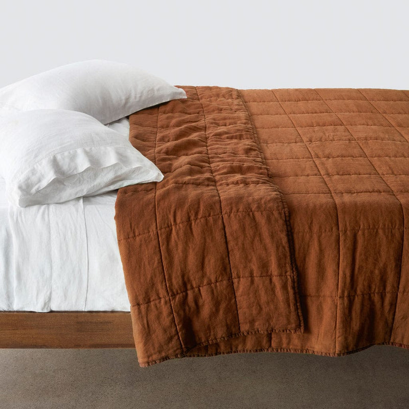 Side of bed with sienna stonewashed linen quilt, sienna