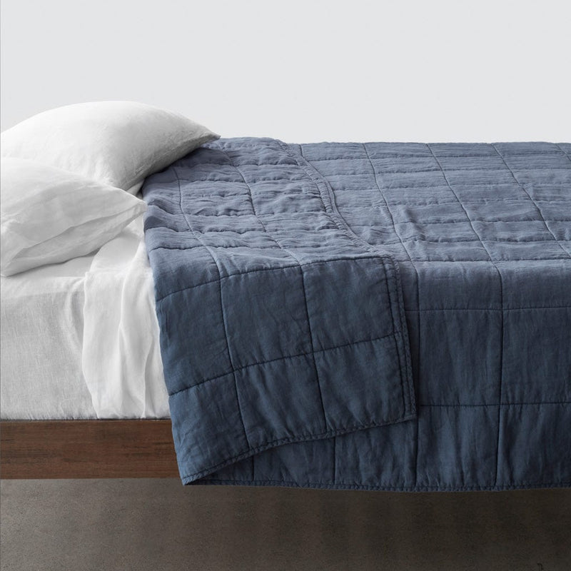 Side of bed with slate blue stonewashed linen quilt, slate-blue