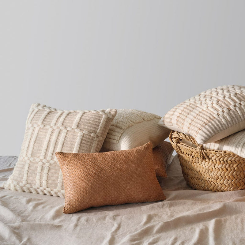 Styled pillow stack with baskets, ecru