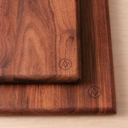 Corner of dark wood serving boards, granadillo