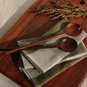 Granadillo serving board with linen napkins and wood serving utensils, granadillo