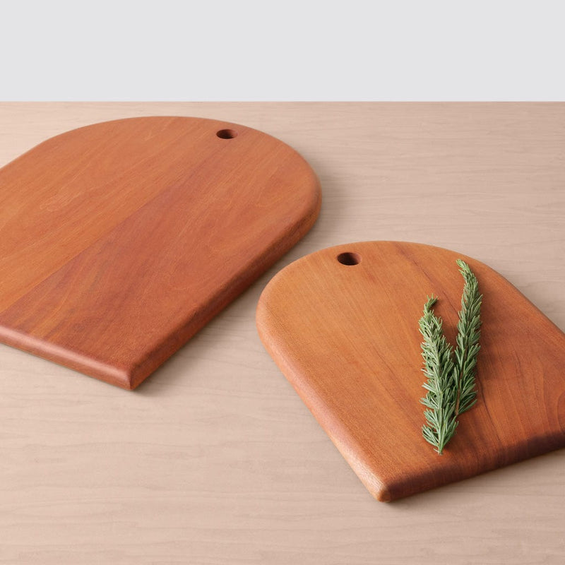 Two mahogany wood serving boards lying on counter, mahogany