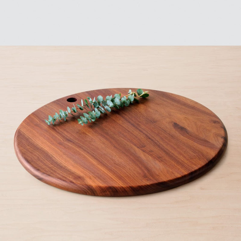 Single granadillo serving board lying on counter, granadillo