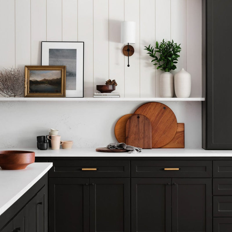 Wooden cutting boards in black and white farmhouse kitchen, granadillo
